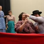 Actresses with Quilters ready quilts while singing Needles Eye to celebrate a mans 21st birthday on the frontier. Some of the women are family members while others are hoping to catch his eye, says director Richard Stephens. Right, SaraJane Benjamin looks to baptize Maddie Montana during a scene. Sequim Gazette photos by Matthew Nash
