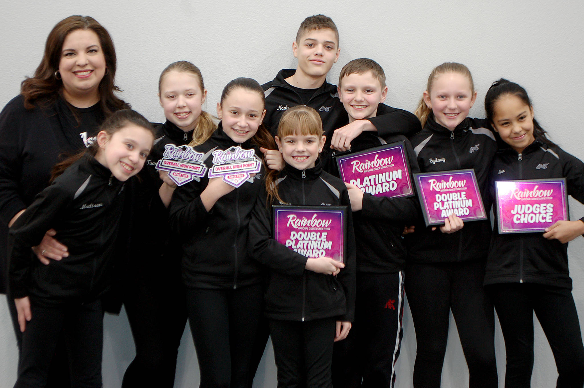 Aspire Academy competitive dance director Erica Edwards, left, and the academys junior competitive dance team stand with their awards won at the Rainbow National Dance Competition. The team consists of, from left, Madison Edwards, Ayla Alstrup, Sofia Divinsky, Noah Jackson, Becca Marshall, Cyrus Deede, Sydney Owens and Eva Lancheros-Gillis. Sequim Gazette photo by Conor Dowley