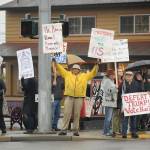 Leroy Martin, and executive board member with the Clallam County Democrats, joins a crowd at the corner of Sequim Avenue and Washington Street on Feb. 5. About 70 protesters braved the wet, cold conditions to voice their displeasure following the impeachment acquittal of President Donald Trump earlier that day. The protest was organized by Indivisible Sequim, whose representatives said prior to the event that, Republican Senators have refused to call witnesses for a fair trial  even though a large majority of Americans want to see witnesses testify. Sequim Gazette photo by Michael Dashiell
