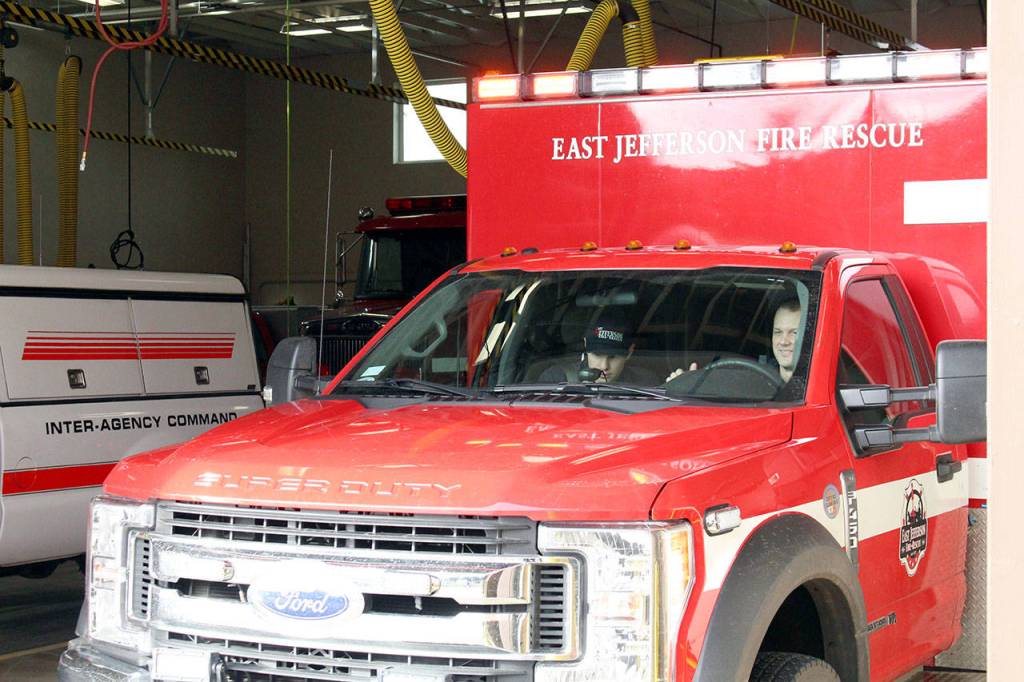 East Jefferson Fire Rescue Lt. Reece Chambers, left, and resident firefighter/EMT Matt Kaldahl leave the Chimacum Fire Station on Friday morning to respond to a medical call on Marrowstone Island. Photo by Zach Jablonski/Olympic Peninsula News Group