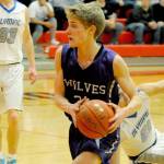 Wolves guard Erik Christiansen (center) drives towards the rim during the first quarter of Sequims 59-47 loss to the Olympic Trojans in an Olympic League tiebreaker game on Feb. 8 that meant the Trojans qualified for the district playoffs. Chrisiansen led the Wolves with 12 points. Sequim Gazette photo by Conor Dowley