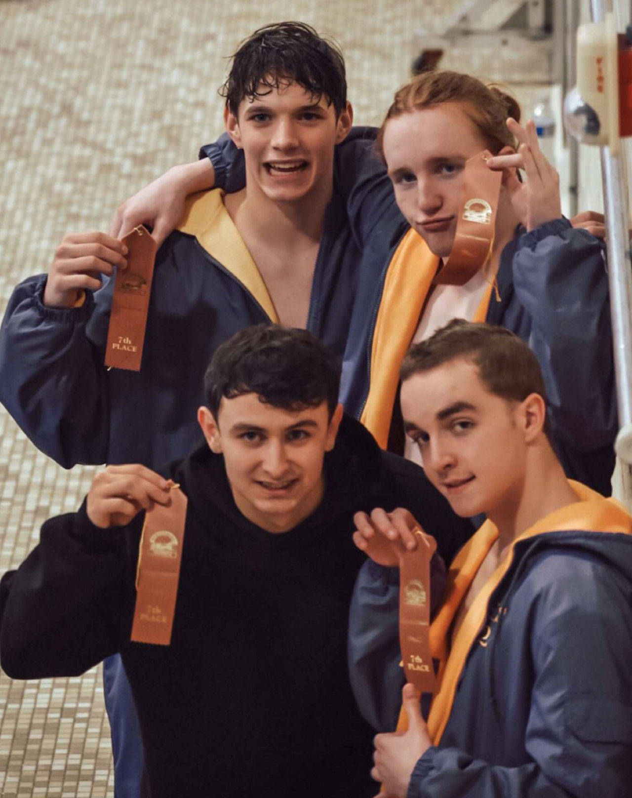 Sequims 400 free relay team of (clockwise from top left) Kaleb Needoba, Jesse Bobst, Miles Tadlock and Zen Graham, celebrate a seventh place finish in the event at the West Central District meet last week. The same quartet had a fourth place finish in the 200 free relay earlier in the meet. Submitted photo