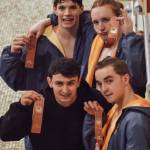 Sequims 400 free relay team of (clockwise from top left) Kaleb Needoba, Jesse Bobst, Miles Tadlock and Zen Graham, celebrate a seventh place finish in the event at the West Central District meet last week. The same quartet had a fourth place finish in the 200 free relay earlier in the meet. Submitted photo