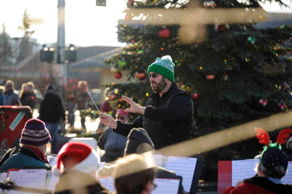 Director Tyler Benedict leads the Sequim City Band in some holiday classic tunes at the annual Home Town Holidays event at Centennial Place on Nov. 30. Benedict helps conduct a joint Sequim City Band/Navy Band Northwest concert on March 1 in Port Angeles. Sequim Gazette file photo by Michael Dashiell