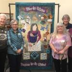 Quilters with the Sunbonnet Sue Quilt Club, from left, Carol Geer, Alanna Levesque, Deni Young, Anna Schenck, Sue Stednick, and Nancy Wilcox, with Norma Herbold not pictured, worked together to create a quilt focusing on womens right to vote. Its a collaboration piece with the League of Women Voters to commemorate the 100th anniversary of womens right to vote. Photo courtesy of Sue Stednick