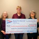 Susan Sorensen, center, presents a check from the Sequim Bay Yacht Club for more than $23,000 to Volunteer Hospice of Clallam County representatives Bette Wood, left, and Astrid Raffinpeyloz. Submitted photo