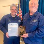 Capt. Linda A. Sturgis, U.S. Coast Guard Sector Puget Sound commander, helps honor Sequims Alan Smith, Sector Puget Sound Auxiliarist of the Year for 2019. Photo by Kent Brown/USCG Auxiliary
