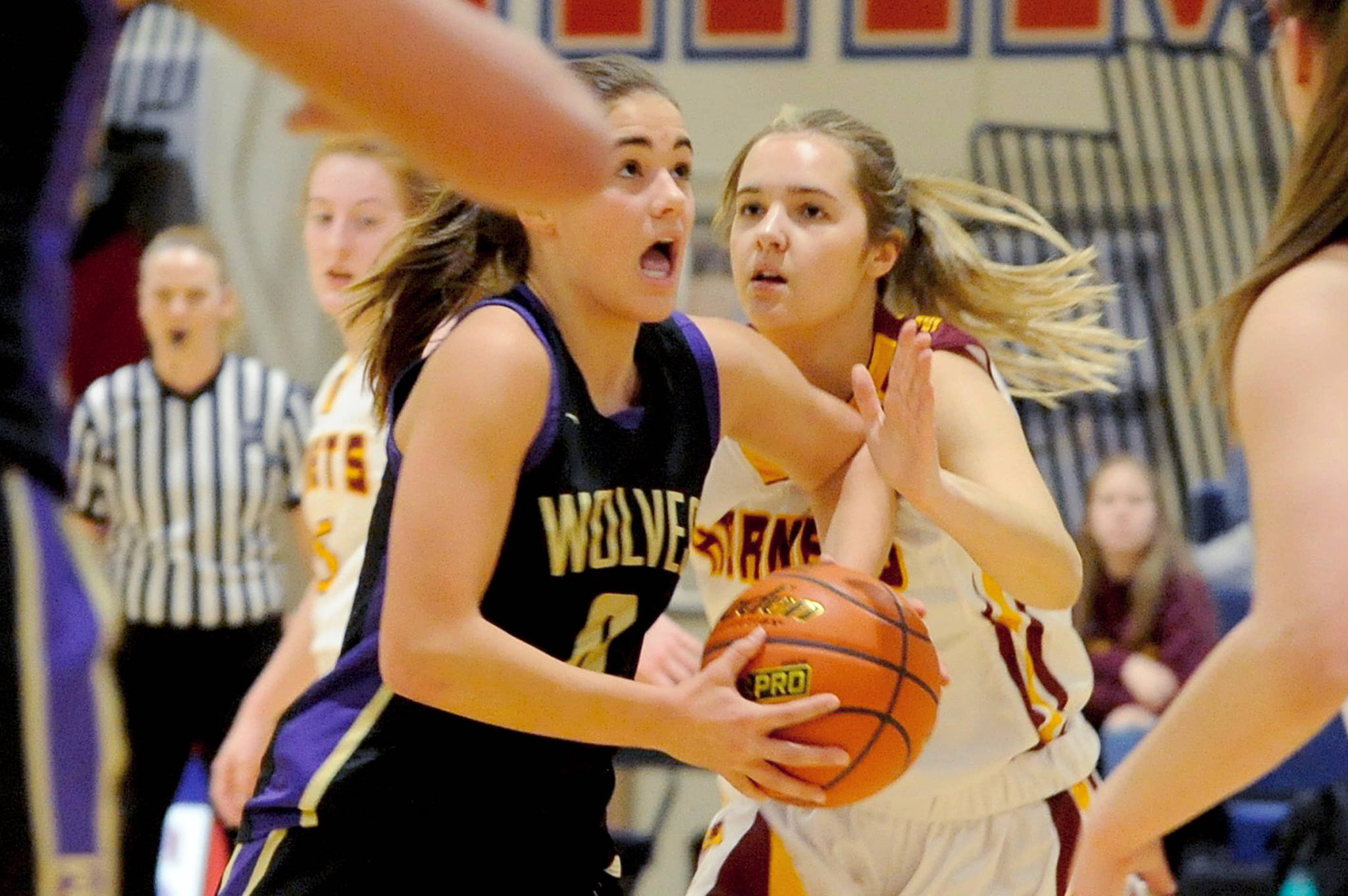 Sequim Wolves forward Hope Glasser drives through traffic to attempt a layup in the third quarter of the Wolves 57-53 loss to the White River Hornets on Feb. 20. Glasser scored seven of the Wolves first 10 points and 11 overall, but the Wolves came up short in the final few minutes against the Hornets in a district playoff loser-out game on Feb. 20 to qualify for the regional round of the 2A State Championships. Sequim Gazette photo by Conor Dowley