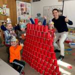 Greywolf kindergarten students Carter Gillaspy, A.J. Lawson, Mason Endicott, Lucas Windrich, and Nevaeh McNeill  pictured here with teacher Sean OMera  celebrate the 100th day of school by stacking 100 cups. Photo by Carla Drescher