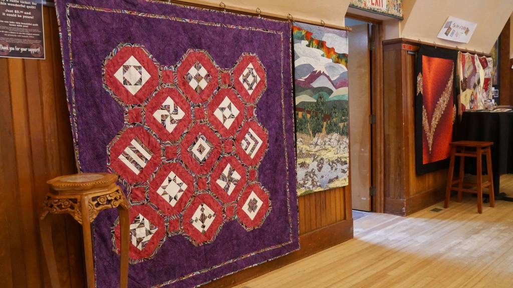 One of the quilts featured in the Olympic theatre Arts exhibit is donated by OTA volunteer Marti McAllister Wolf, and will be promoted as a raffle item to benefit the theater.