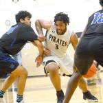Peninsula Colleges Davien Harris-Williams drives against Edmonds on Saturday night. Harris-Williams scored 34 points to help lead the Pirates to a 111-98 win over the Tritons to qualify for the NWAC Tournament. (Jesse Major/for Peninsula Daily News)                                <strong>Jesse Major</strong>/for Peninsula Daily News                                Peninsula Colleges Davien Harris-Williams drives against Edmonds on Saturday night. Harris-Williams scored 34 points to help lead the Pirates to a 111-98 win over the Tritons to qualify for the NWAC Tournament.