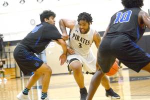 Peninsula Colleges Davien Harris-Williams drives against Edmonds on Saturday night. Harris-Williams scored 34 points to help lead the Pirates to a 111-98 win over the Tritons to qualify for the NWAC Tournament. (Jesse Major/for Peninsula Daily News)                                <strong>Jesse Major</strong>/for Peninsula Daily News                                Peninsula Colleges Davien Harris-Williams drives against Edmonds on Saturday night. Harris-Williams scored 34 points to help lead the Pirates to a 111-98 win over the Tritons to qualify for the NWAC Tournament.
