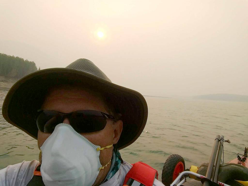 John Kuntz wears a face mask as he paddles, trying to avoid the smoke from 600 active forest fires in British Columbia. Submitted photo