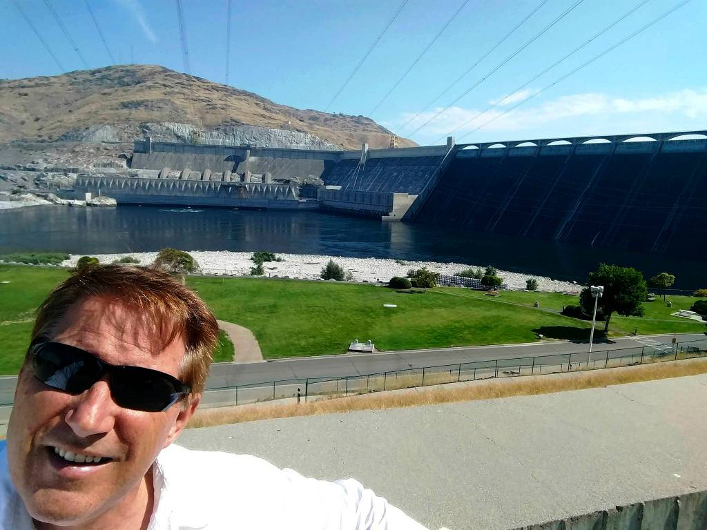 Left, John Kuntz pictured in front of Grand Coulee dam at mile 608  the halfway of his trip. Submitted photo