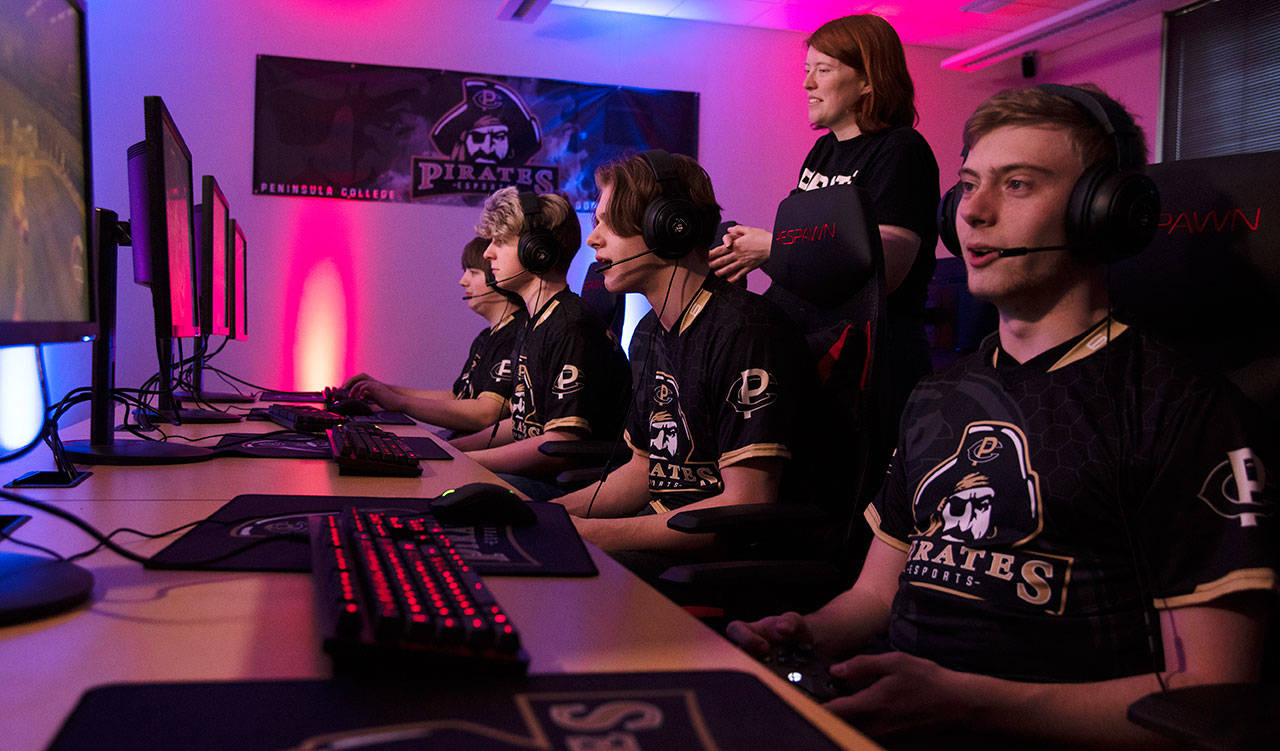 The Pirate Rocket League team of (from left) Nicholas Charters, Logan Beebe, Stuart Koehler and Drew Eckard compete, with coach Charlie Morrow looking on. The team takes on the University of Connecticut on March 11. Photo by Rick Ross