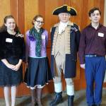 Essay winners from the Michael Trebert Chapter of the Daughters of the American Revolution essay contest are, from left, Queen of Angels sixth-grade Grace Rogers, Olympic Peninsula Academy eighth-grader Georgia Bullard, and Queen of Angels seventh-grader Drake Austin, standing with George Washington (Vern Frykholm of Sequim). More than 90 students entered the essay contest in grades 5-8. Submitted photo