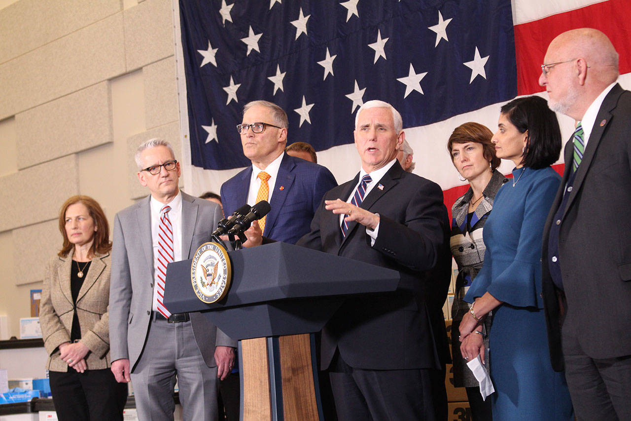 Vice President Mike Pence, center, and Washington Gov. Jay Inslee, to his left, along with state and federal officials, discuss a cooperative response to the COVID-19 coronavirus on March 5. Photo by Cameron Sheppard/WNPA News Service