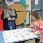 Teacher Teresa Iversen looks on as student Anara Miles considers a math challenge at Greywolf Elementarys Family Math Night on Feb. 27. Photo by Kalli Wiker