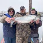 Bellinghams Brandon Leeper, center, caught this 15.7-pound hatchery chinook off Port Townsend on March 13 and was atop leaderboard after the first day of the Olympic Peninsula Salmon Derby. Leepers catch went on to win the event. Photo courtesy of Olympic Peninsula Salmon Derby