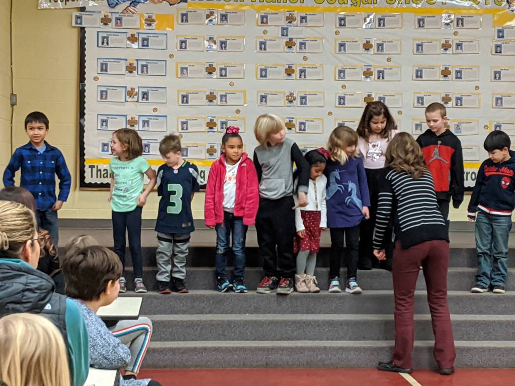 Students at Helen Haller Elementary School line up with help from school principal Becky Stanton to receive their Shout Outs in the gym. From left are: Jack Jacobson, Violet Steed-Gonzalez, Bradly Dormer, Madison Johnson, Nathan Coates, Eulalia Gonzales, Sophie Christian, Corrine Piersoll, Aden Uhlig, and James Melvin. Photo by Stephanie Dormer