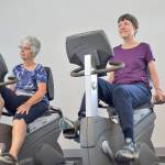 Linda Flores of Port Angeles, left, and Mary Farley of Sequim cycle at the YMCA of Sequim during a workout with the Exercise and Thrive program. The three Olympic Peninsula YMCA facilities are closing through March 31. Sequim Gazette file photo by Matthew Nash