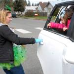 Lucy Wait, a paraeducator at Hamilton School, left, opens the door for student Chloe Sullivan, 7, to receive a free lunch and breakfast at the school on March 17. Youngsters at Hamilton were also given a chance to pick a free book to take home. Photo by Keith Thorpe/Olympic Peninsula News Group