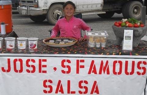 Abby Garcia displays products at her parents Joses Famous Salsa booth at the Sequim Farmers & Artisans Market in 2010. Photo courtesy of Angela Garcia