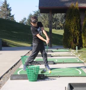 Gideon Ryder, 10, of Lake Forest Park, drives a few balls at The Cedars at Dungeness driving range last week. Sequim Gazette photo by Michael Dashiell