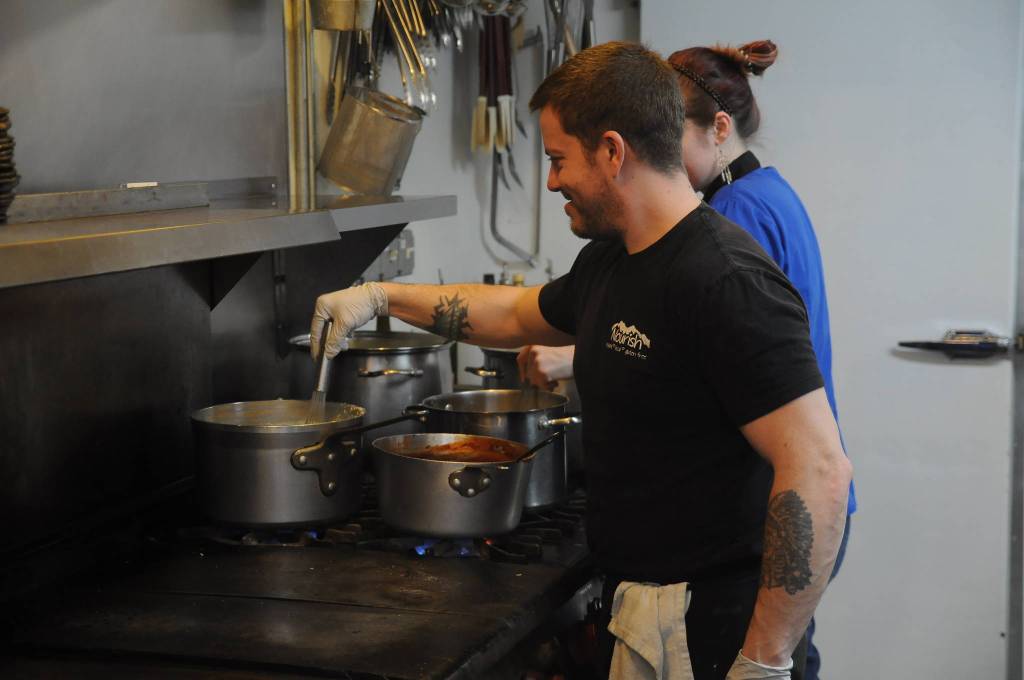 Ryan Quiroz and Alicia Taylor help prepare food at Nourish Sequim on March 26. Nourishs Meals for Medics GoFundMe drive, a program to provide meals for Olympic Medical Center workers, topped its initial goal of $10,000. Sequim Gazette photo by Michael Dashiell