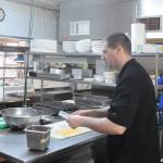 Jesse Taylor preps some food in the kitchen at Sequim Nourish in March 26. Sequim Gazette photo by Michael Dashiell