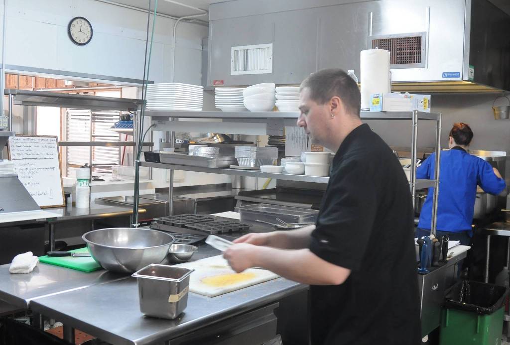 Jesse Taylor preps some food in the kitchen at Sequim Nourish in March 26. Sequim Gazette photo by Michael Dashiell