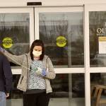 Janine Warren, a medical assistant-apprentice, takes the temperature of a visitor to the Olympic Medical Physicians Clinic at 907 Georgiana St., in Port Angeles. After they are checked for fever, each person is given a visitor/patient tag and asked to use hand sanitizer before entering the clinic. (Dave Logan/For Peninsula Daily News)