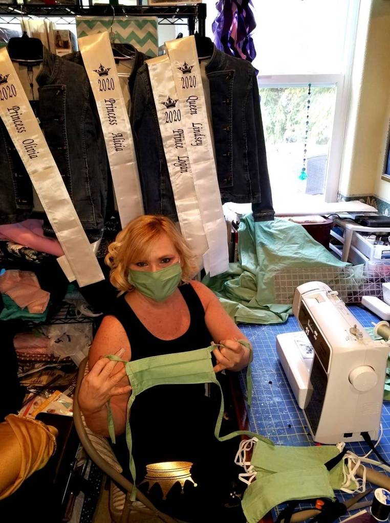 Lynn Horton holds up one of the many masks shes helped make for the community and first responders and health workers. Submitted photo