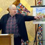 Richard Doc Robinson, executive director of Serenity House of Clallam County, points to an artists rendering of the Bridges Grill and a nearby laundromat on Eighth Street in Port Angeles that were under consideration for purchase by his agency to provide services for homeless young adults in this Dec. 15, 2018, file photo. Robinson has left his post at Serenity House. Photo by Keith Thorpe/Olympic Peninsula News Group