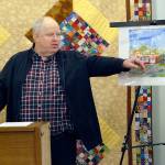 Richard Doc Robinson, executive director of Serenity House of Clallam County, points to an artists rendering of the Bridges Grill and a nearby laundromat on Eighth Street in Port Angeles that were under consideration for purchase by his agency to provide services for homeless young adults in this Dec. 15, 2018, file photo. Robinson has left his post at Serenity House. Photo by Keith Thorpe/Olympic Peninsula News Group