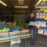 Nashs Farm Stand owner Patty McManus shows a low-contact way to buy local vegetables, camelina oil, flour, grain and eggs. Photo by Emma Jane Garcia