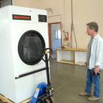 Kevin Lopiccolo, deputy director of Clallam County Health and Human Services, looks over a newly-delivered commercial clothes dryer to be installed last week in the Port of Port Angeles 1010 Building near William R. Fairchild International Airport prior to the buildings temporary conversion to an isolation shelter of homeless individuals. Photo by Keith Thorpe/Olympic Peninsula News Group
