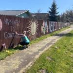 For about a week, Katie Smith worked with her children and some neighbors to draw an inspirational chalk mural along her subdivisions fence facing South Sequim Avenue. Photo courtesy of Isaac Peiffer