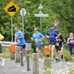 Runners in the 2017 North Olympic Discovery Marathon cross Whitefeather Way in Sequim. This years event, NODMs 18th, has been moved to virtual races with concerns of large group gathering exacerbating the novel coronavirus threat. Sequim Gazette file photo by Michael Dashiell