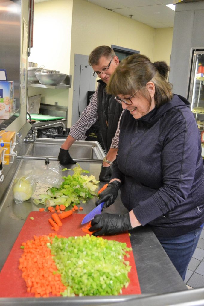 Barbara and Mike Lippert prep vegetables for soups to be delivered to apartment complexes from the Sequim Boys & Girls Club. They were some of the first volunteers to step up to help prepare soups for local apartment complexes. Sequim Gazette photo by Matthew Nash