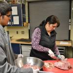 Andy and his mom Anita Benitez prep ham for split pea and ham soup during a recent night of soup prep. Anita is one of many Sequim School District staffers volunteering with the program. Sequim Gazette photo by Matthew Nash