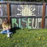 Payton Sturm sits by her familys fence after it was decorated by family-friend Shenna Younger as part of the Adopt a Senior project. Payton and seniors across the country have lost out on many milestones in the final months of high school, so multiple groups including one in Sequim look to encourage local seniors in different ways. Photo courtesy of Payton Sturm