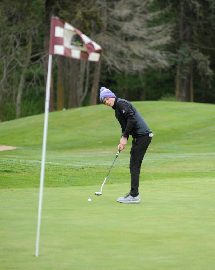 Sequim Highs Ben Sweet, then a fresman, looks to sink a putt on the first hole at The Cedars at Dungeness in 2019. Sequim Gazette file photo by Michael Dashiell