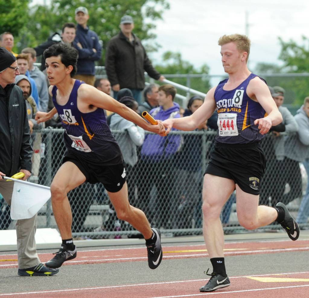 Above, Sequims Logan Laxson, right, hands off to teammate Darren Salazar in the 4x100 relay preliminaries at the state 2A track and field championships in Tacoma in 2019. Sequim placed sixth in the finals and helped the Wolves win its first boys state championship in school history. Below, Sequim High freshman shortstop Hannah Bates looks to make a play at a preseason practice in early March. Bates and the Wolves saw their 2020 spring season suspended before playing their first game in mi-March. Sequim Gazette file photos by Michael Dashiell