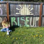 Payton Sturm sits by her familys fence after it was decorated by family-friend Shenna Younger as part of the Adopt a Senior project. Payton and seniors across the country have lost out on many milestones in the final months of high school, so multiple groups including one in Sequim look to encourage local seniors in different ways. Photo courtesy of Payton Sturm