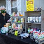 Sheila Gregg, owner of Smoothie Essentials Handmade Soaps, does a test run of her modified booth with essential product for opening day the Sequim Farmers & Artisans Market, set for Saturday, May 16. Photo by Emma Jane Garcia