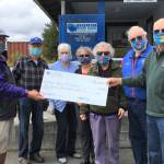 At right, Ted Lund, treasurer of the Kiwanis Club of Sequim-Dungeness, presents a donation to Stephen Rosales of the Sequim Food Bank (at far left). Also in attendance are, from second-to-left, club members Wayne Boden (president), Mary Boden, Philomena Lund (secretary), Janice Teeter and Richard Fleck (past president). Submitted photo