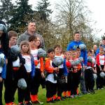 Players and coaches stand for The Star Spangled Banner at Sequim Little Leagues opening day ceremony in April 2019. This years season has been cancelled with concerns of the spread of the 2019 novel coronavirus. Sequim Gazette file photo by Matthew Nash