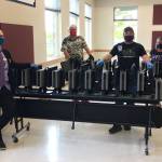 With refurbished computers donated by the Sequim PC Users Group, Sequim School Districts IT staff, from left, Director Beau Young, Richard Seiler, Scott Harmsen and Maria Seabolt helped distribute more than 100 computers for families without the technology in their homes to participate in distance learning for grades 6-12. Sequim Gazette photo by Matthew Nash