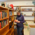 Jean Rucker, a 13-year volunteer with Friends of Sequim Library, prepares materials to sell during the Friends book sale earlier this year. NOLS staff are preparing a grant application for state funding to enlarge the Sequim Library facility on North Sequim Avenue. Sequim Gazette file photo by Matthew Nash